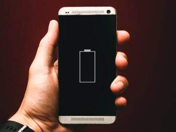 person holding low battery smartphone