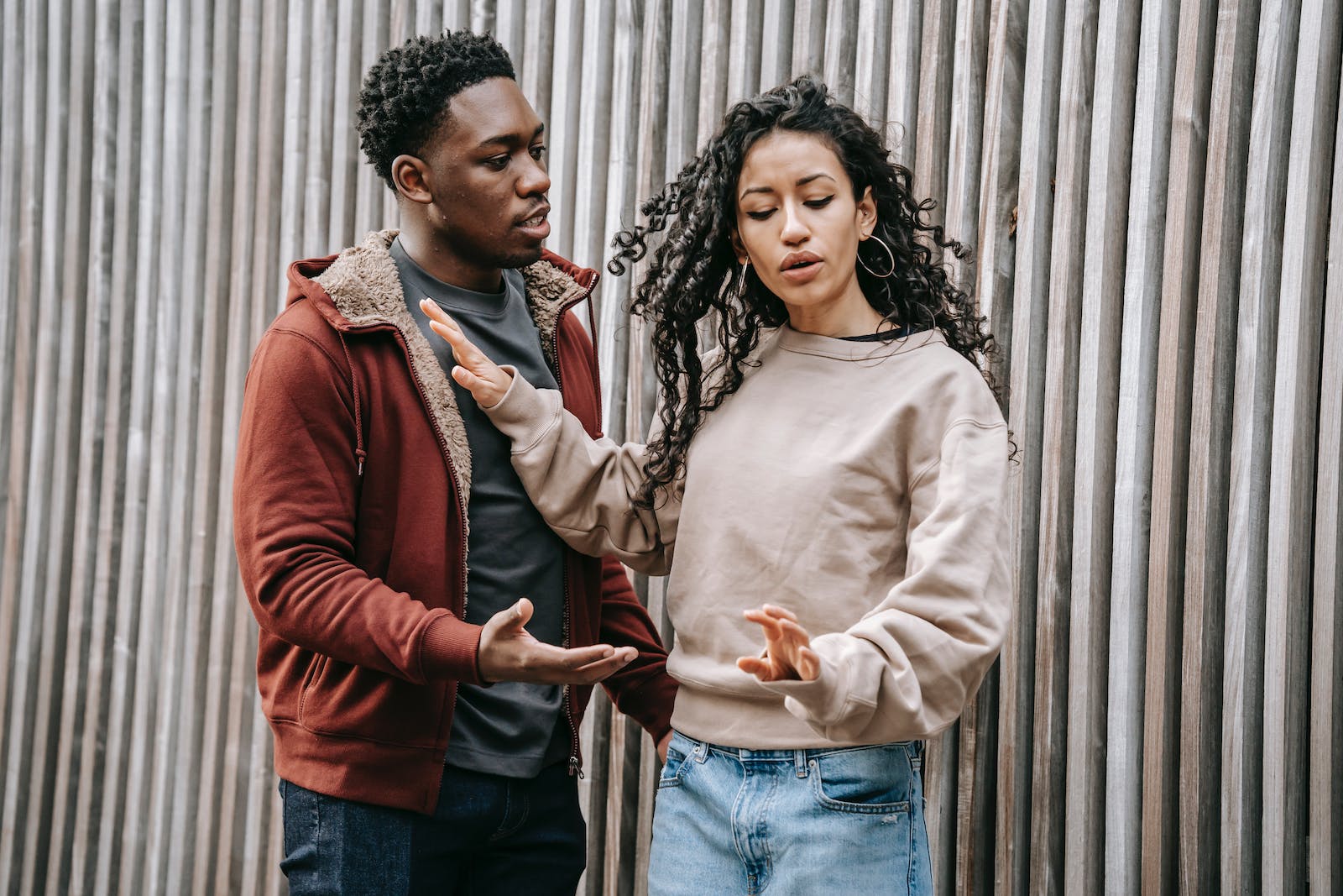 Frustrated multiethnic couple having argue on street