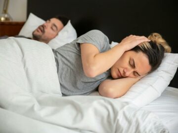 A Frustrated Woman Trying to Sleep
