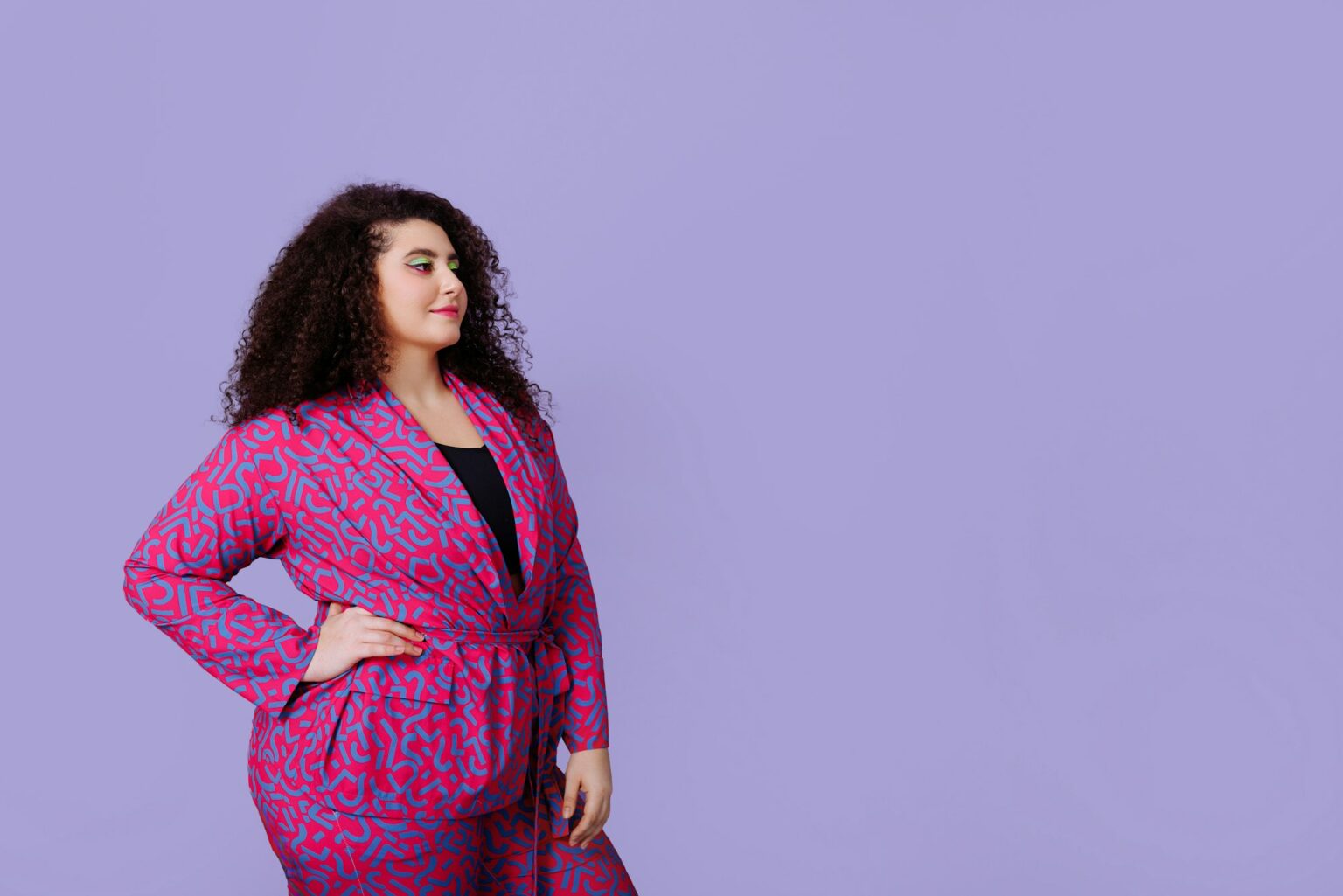 5 looks tendance pour paraître plus mince tout en restant stylée A young woman with a plus size figure with an Afro hairstyle