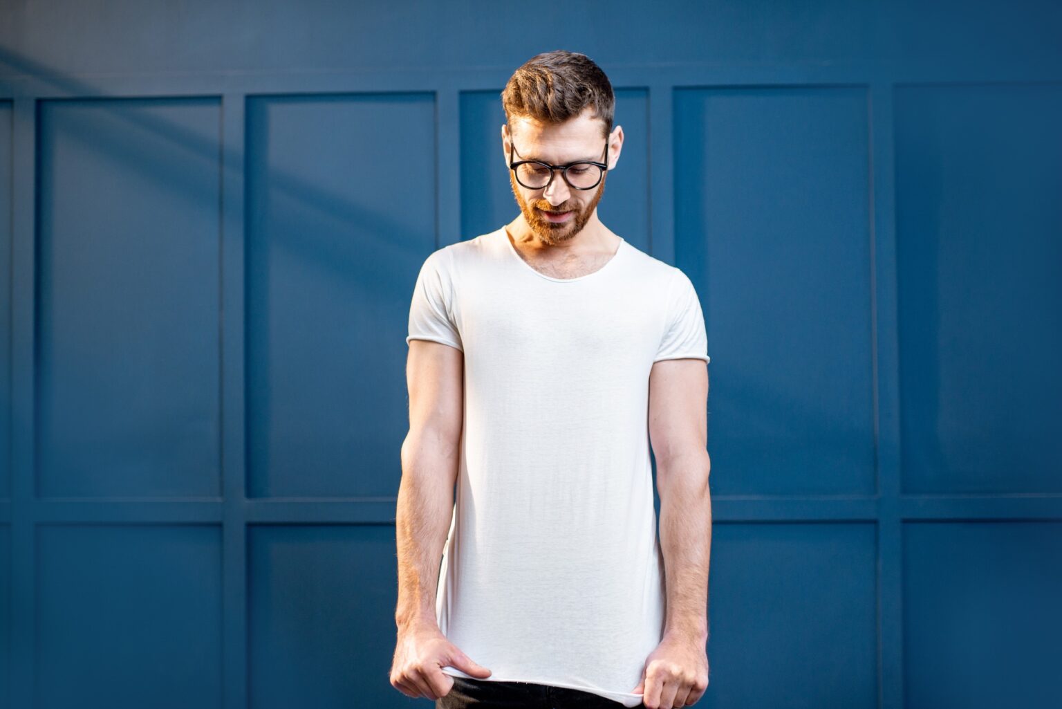 Man in white t-shirt on the blue background