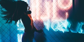 Dancing silhouette of girl in a nightclub.